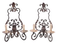 A set of four wrought iron twin-light wall appliques,