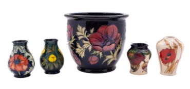 Five pieces of John Moorcroft pottery comprising a jardiniere in the Anemone pattern, 17cm high,
