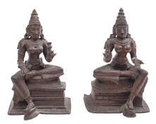 A pair of South Indian bronze figures of the Hindu goddesses Sri Devi and Bhu Devi a royal ease on