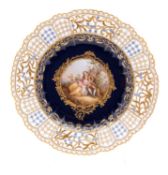 A Meissen porcelain cabinet plate with pierced rim the centre enamelled with a scene after Watteau,