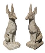 A pair of reconstituted stone pier finials modelled as stylised dogs, perhaps Dobermanns,