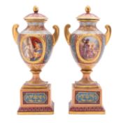 A pair of Austrian porcelain pedestal vases and covers decorated front and verso with classical