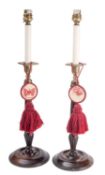 A pair of Edwardian walnut and brass candlesticks in George II style,
