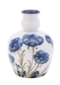 A William Moorcroft Florian Ware vase of oviform with bulbous neck tube lined in the Blue Poppy
