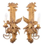 A pair of carved giltwood single light wall appliques in Rococo taste,