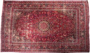 A Tabriz carpet, the wine field with a central flowerhead pole medallion,