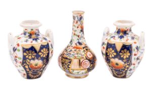 Three toy Derby porcelain vases comprising a pair of two handled oviform vases and a pear shaped