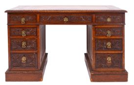 A Victorian carved oak pedestal desk,