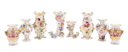 A group of eight Coalport and other flower-encrusted vases, 19th century comprising two pairs,