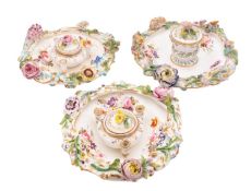 A pair of Coalbrookdale inkstands and one similar, circa 1830 with covers,