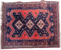 A Hamadan rug, the indigo and brick red field with triple ivory medallions with cruciform designs,