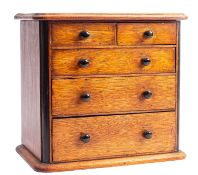 A miniature Victorian oak and ebonised chest of drawers, possibly an apprenticeman's piece,