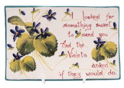 A Wemyss pin tray of rectangular form decorated by Edwin Sandland with violets and the text