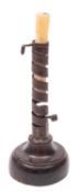 A wrought iron and stained hardwood mounted 'rat de cave' candlestick,