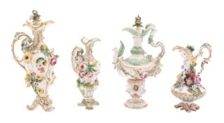 A group of four Coalport flower-encrusted ewers and three stoppers,