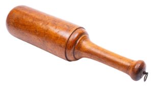 A substantial turned treen pestle, 19th century; with metal swing ring to the waisted handle,