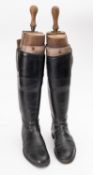 A pair of black leather riding boots, unsigned with wooden trees, length of sole, 29.