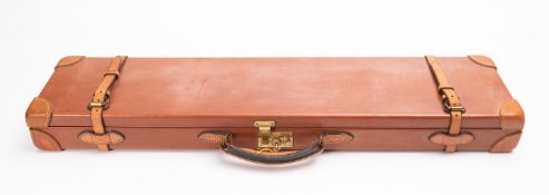 A brown leather gun case, unsigned, to fit 30 inch barrels, with gold coloured fittings.
