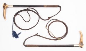 Two Swaine black leather antler handled riding whips,