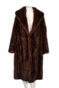Two mid 20th century three quarter length fur coats, unsigned, with brown silk linings.