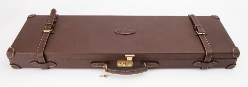 A Guardian Leather gun case, with green felt interior fitted for 28 to 34 inch barrels,