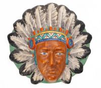 A Burleigh Ware wall mask in the form a of a native American Chief's head in traditional headdress.