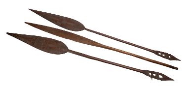 A pair of Oceanic carved paddles, with plain shafts and pierced ends,