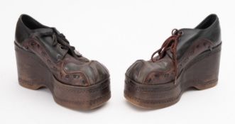 A pair of 1970s two-tone leather platform shoes, size 7 with eight eyelets and moulded soul,
