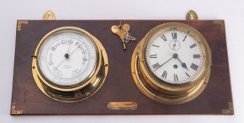 A matched brass bulkhead clock and barometer set,