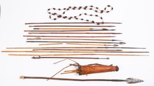 A collection of various tribal and other arrows and a leather quiver.