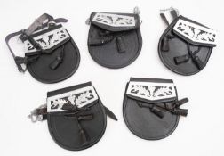 A group of five black leather Pipe band sporrens.
