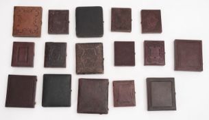 A collection of sixteen cased Ambrotype portraits.
