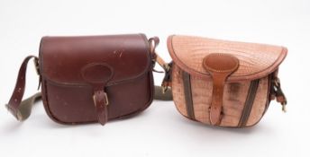 A pair of brown leather cartridge bags, one with faux crocodile skin,