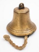 An 8 inch ship's bell, unsigned, arched suspension over body with iron clapper and rope pull,