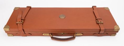 A tan leather and brass gun case, oak carcass with fitted interior for 29 inch barrels.