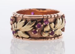 A bi coloured 14k marked band with rubies.
