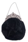 A late 19th/ early continental pierced silver mounted handbag, decorated in relief with putti,