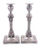 A pair of Old Sheffield plate candlesticks, on canted square bases,