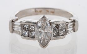 A Platinum, Marquise Diamond Cluster Ring, the marquise single stone diamond claw set at the centre,
