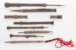 A collection of eight silver and white metal propelling pencils and a plated dip pen, include S.