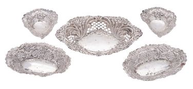 Five Victorian silver bonbon dishes, with pierced sides and embossed foliate scroll decoration,