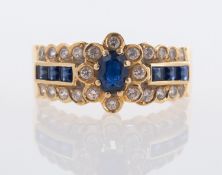 A modern continental synthetic sapphire and white stone ring marked 750 to outside