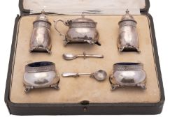 A George V cased five-piece silver condiment set, circular form,