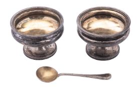 A pair of Victorian silver pedestal salts, circular form, with bead borders and gilt interiors,