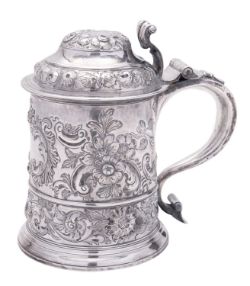 A George I silver tankard, tapering circular form, with a scrolling thumb-piece,