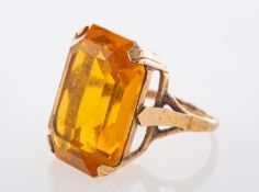 A 9ct. gold and citrine single stone ring, claw set with an emerald-cut citrine,