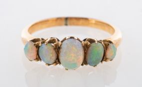 An antique five stone opal ring, claw set with five graduated oval opal cabochons,
