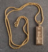A mid 1970s 9ct gold ingot. Stamped 375 to the face on a 9ct gold articulated chain, 42g gross.
