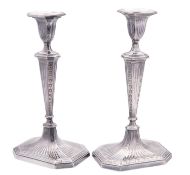 A pair of Old Sheffield plate candlesticks, on canted rectangular bases,