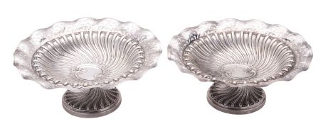 A pair of late Victorian silver pedestal bonbon dishes, of shaped circular outline,